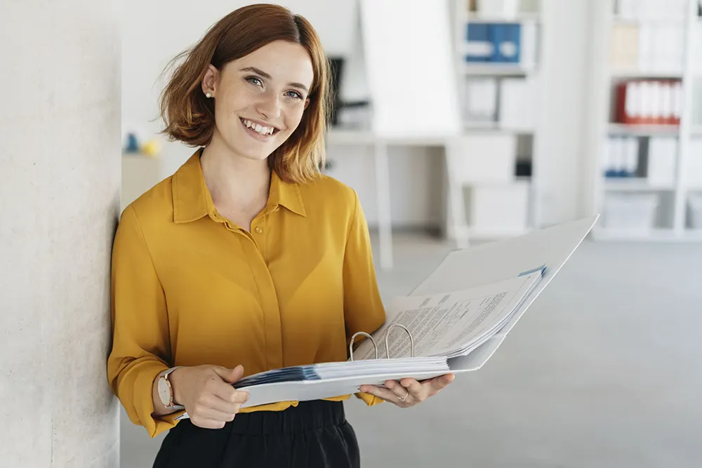 corporate woman with minute book in office